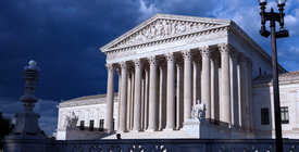 Supreme Court with storm clouds behind