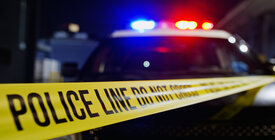 Crime scene tape and police car