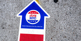 VoteNYC on arrow signage on ground