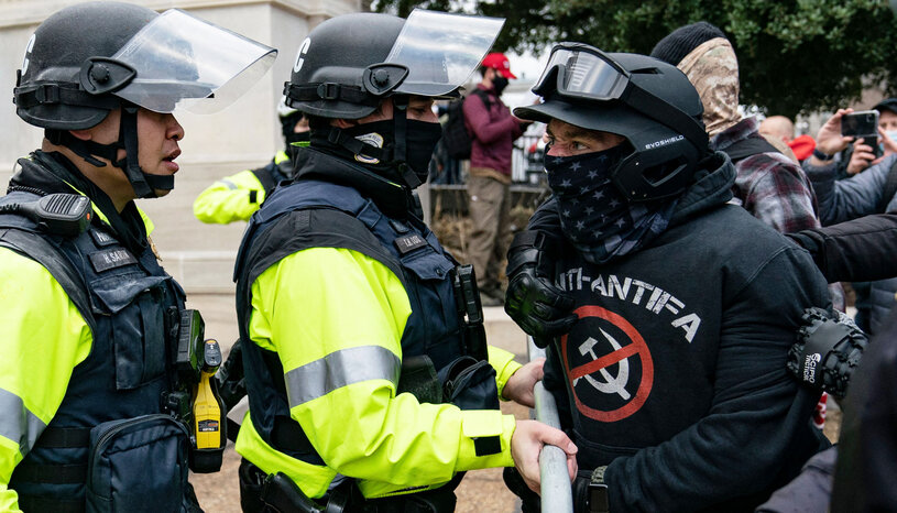 A participant in the January 6th riot confronts police