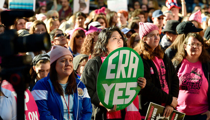 Protesters hold signs during the Women's March on January 19, 2019 in Los Angeles, California.