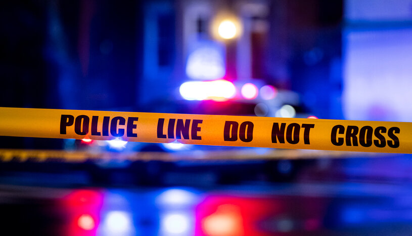 police tape foreground and siren lights
