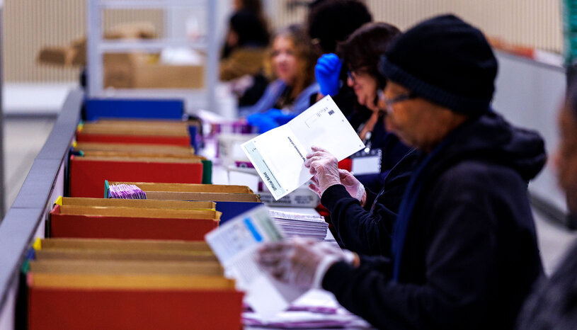 Election workers handling ballots