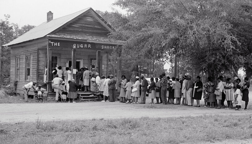 Historical image of Black voters in line at a polling place