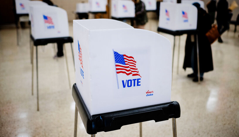 voting booth with United States flag on side