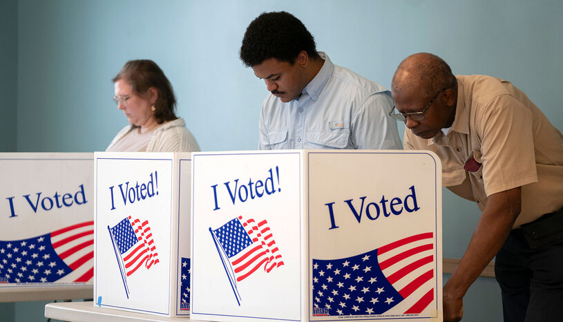 Three people voting at booths with I Voted imagery