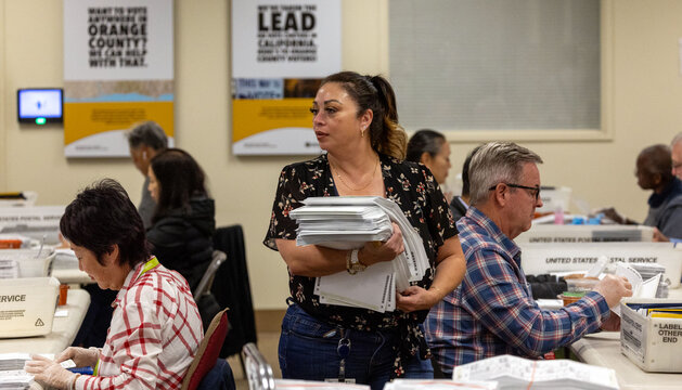 Election official holding stack of papers