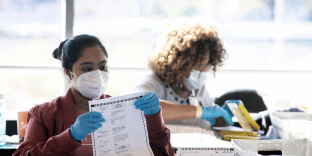 election workers looking at ballots