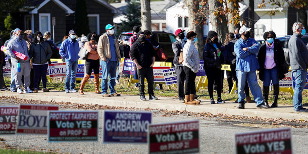 Voters stand in a long line at their polling place