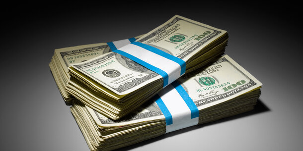 Three stacks of $100 dollar bills