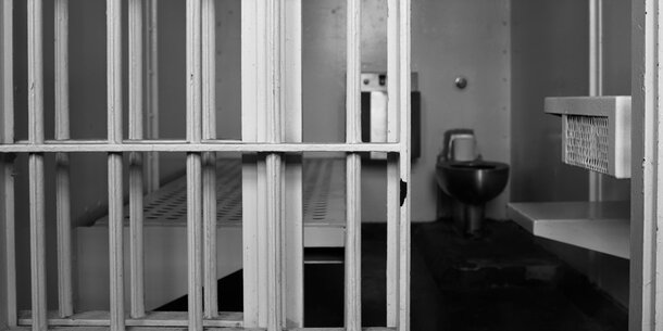 Black and white image of jail cell