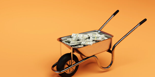 A wheelbarrow full of cash
