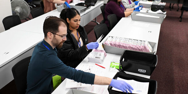 Election workers handling ballots