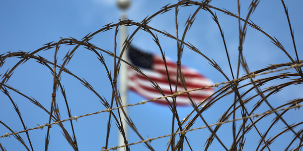 Flag behind barbed wire