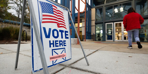 "Vote here" sign outside a polling place