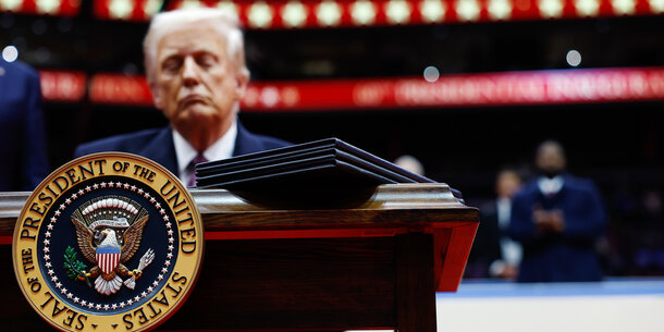 Donald Trump with presidential seal in foreground