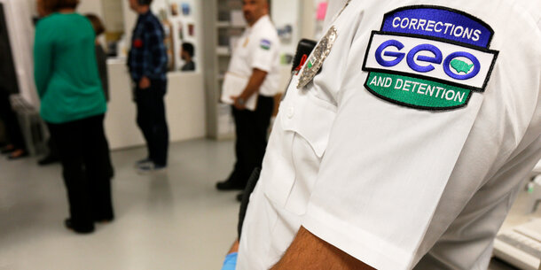 GEO Group logo on sleeve in foreground