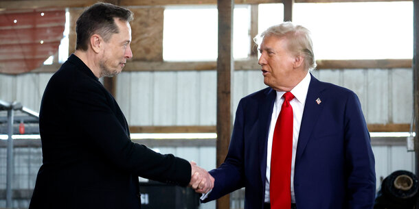 Elon Musk shaking hands with Donald Trump