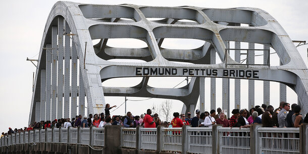 People marching on Edmund Pettus Bridge in Selma, AL