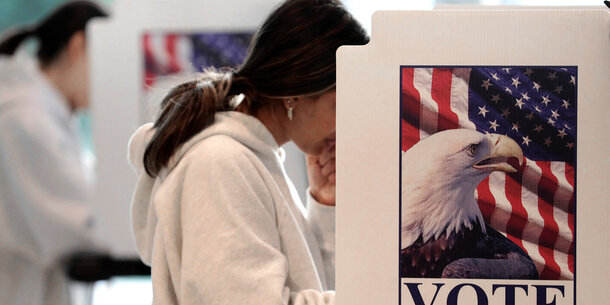 Woman voting behind divider