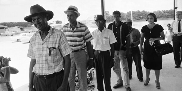 Voters wait in line to apply for registration in Buras, Louisiana.