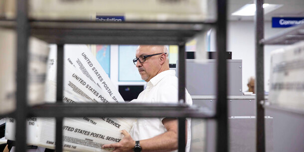 Election official handling ballots