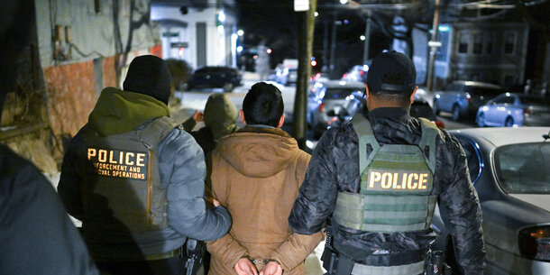 Immigration and Customs Enforcement officers arrest a man.