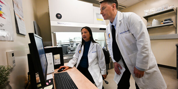 Two scientists looking at a computer