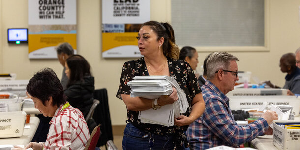 Election official holding stack of papers