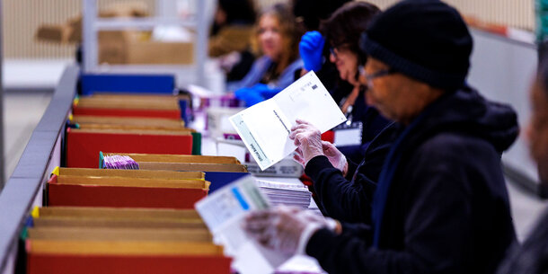 Election workers handling ballots