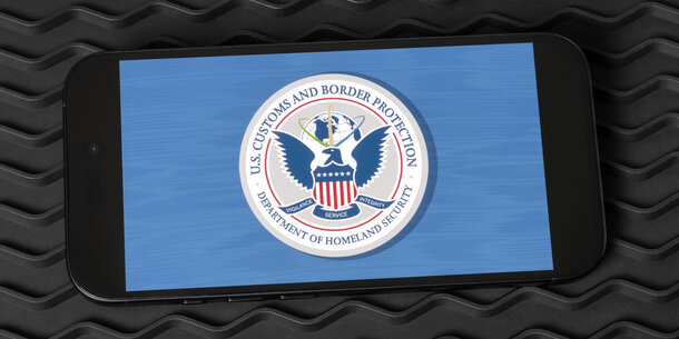 Graphic of DHS seal displayed on a smartphone screen
