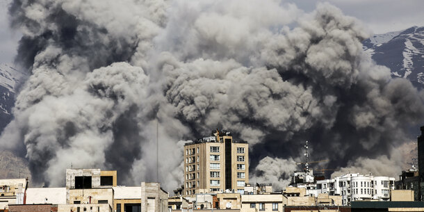 A bomb strike sends up a huge cloud of smoke in Teheran