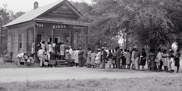 Historical image of Black voters in line at a polling place