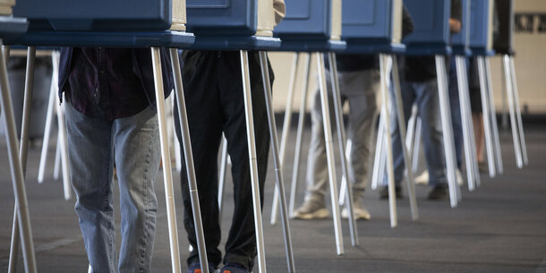voting booths, legs only visible
