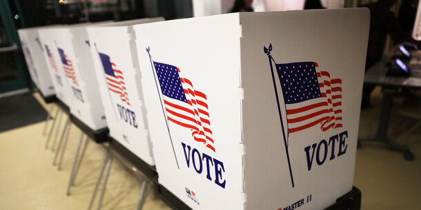 Voting booths with American flag