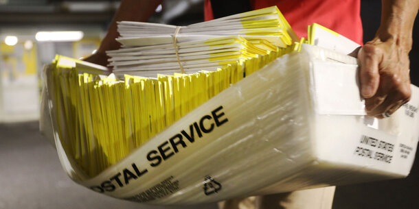 person carrying mail ballots 