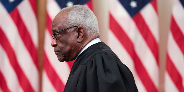 Clarence Thomas with American flags in background