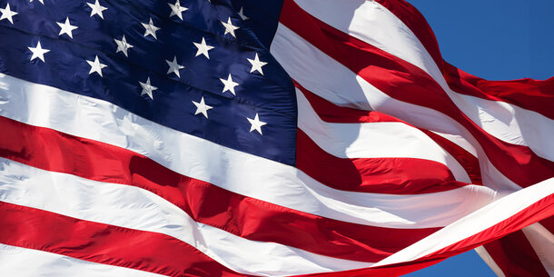 waving American flag against blue sky
