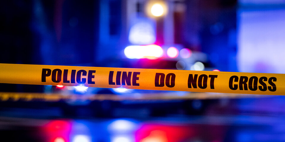 police tape foreground and siren lights