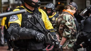 Militarized looking police officer with rifle