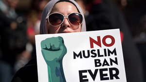 Protestor holding "No Muslim Ban Ever" sign