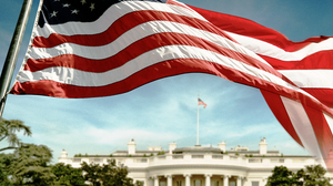 An American flag flies in front of the White House