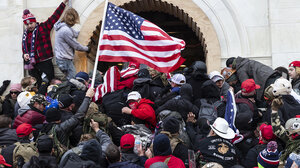 Insurrectionists pile on top of one another at the US Capitol on Jan. 6, 2021.
