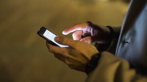 A person holding a smartphone while using a social media app.