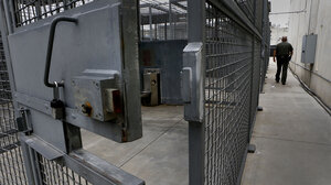 A close-up shot of the door of a prison cell.