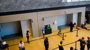 People wait in line to vote early at the State Farm Arena in Atlanta