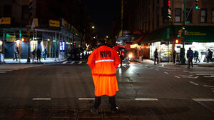 NYPD officer in an orange jacket.