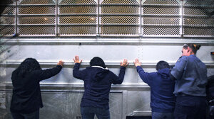 Imprisoned women being searched