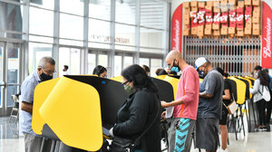 Voters cast their ballots in a sports stadium