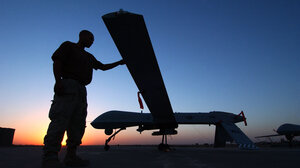 Man stands next to drone